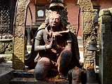 Kathmandu Changu Narayan 21 5C Life Size Garuda Statue Kneels In Front Of Main Entrance To Changu Narayan Temple Facing the main entrance to the Changu Narayan Temple is a life size 5C statue of a kneeling Garuda, the carrier of Lord Vishnu, with a snake around his neck and his hands together saying Namaste.